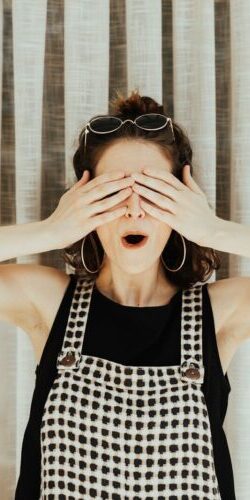 woman covering eyes with hand